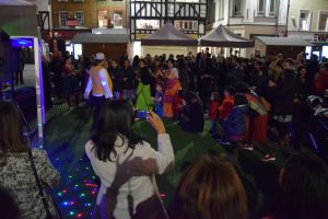 Entertainer, Jay Kumar leads the crowd to dance during the Diwali festival celebrations in Kingston