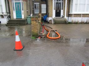 Water is pumped out of houses on the riverfront in Hampton Court 