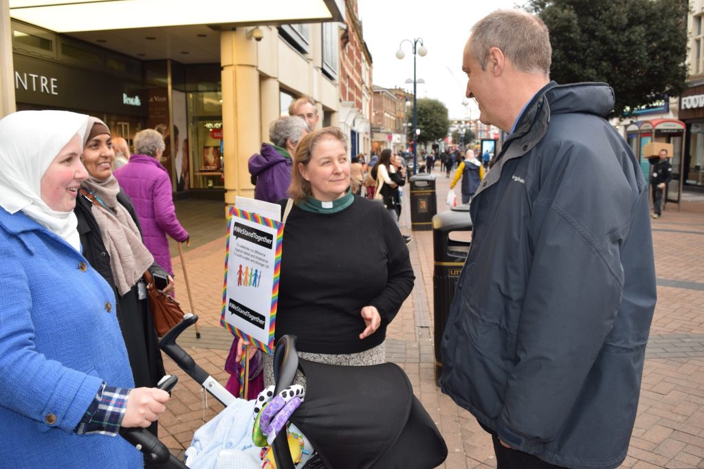 Members from Kingston Interfaith Forum exchanges ideas with the public outside the Bentall Centre during a vigil for the victims of the Westminster attack