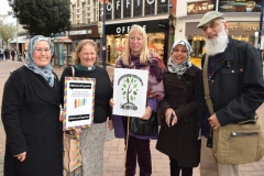 Interfaith group members pose for photo outside the Bentall shopping centre in Kingston during a vigil for the victims of the Westminster attack
