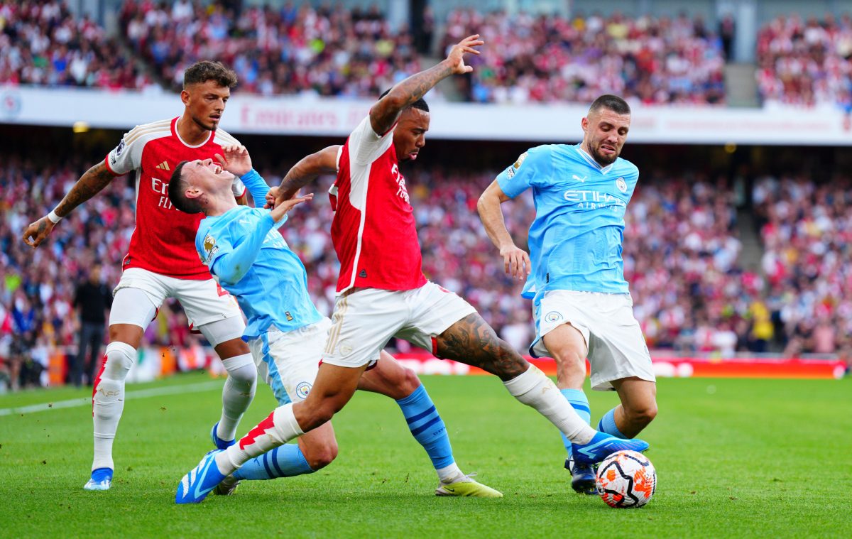 A skirmish in a football game between Arsenal and Manchester City