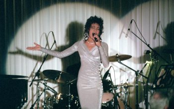 Whitney Houston performing in front of a band