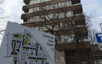 A map of the Cambridge Road Estate in front of a tall building